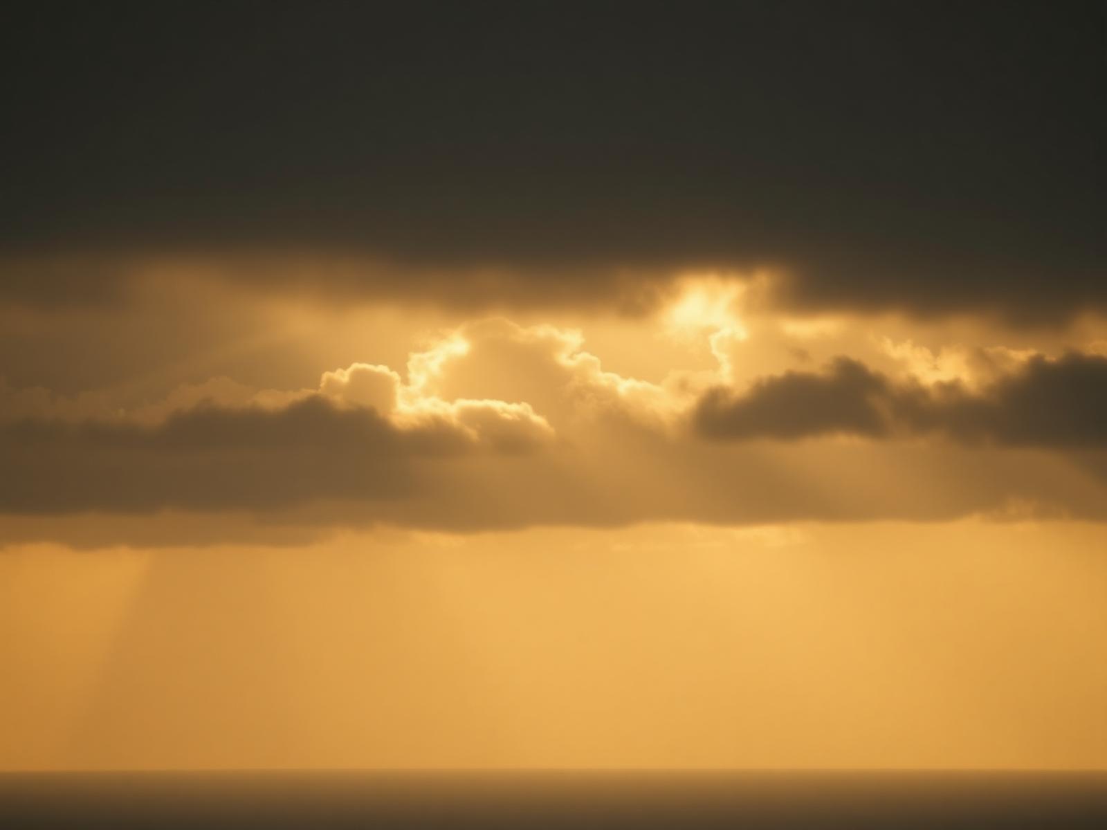 Golden light breaking through clouds at dawn